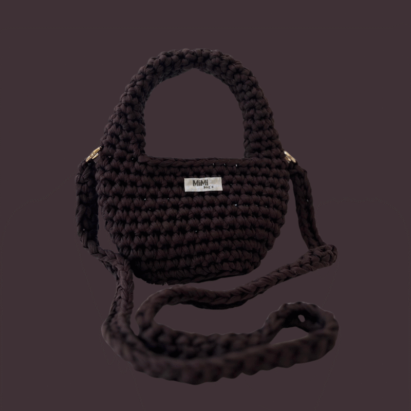 Rjava torbica Elegant Arc mini iz kolekcije mimibags, postavljena na enobarvnem ozadju